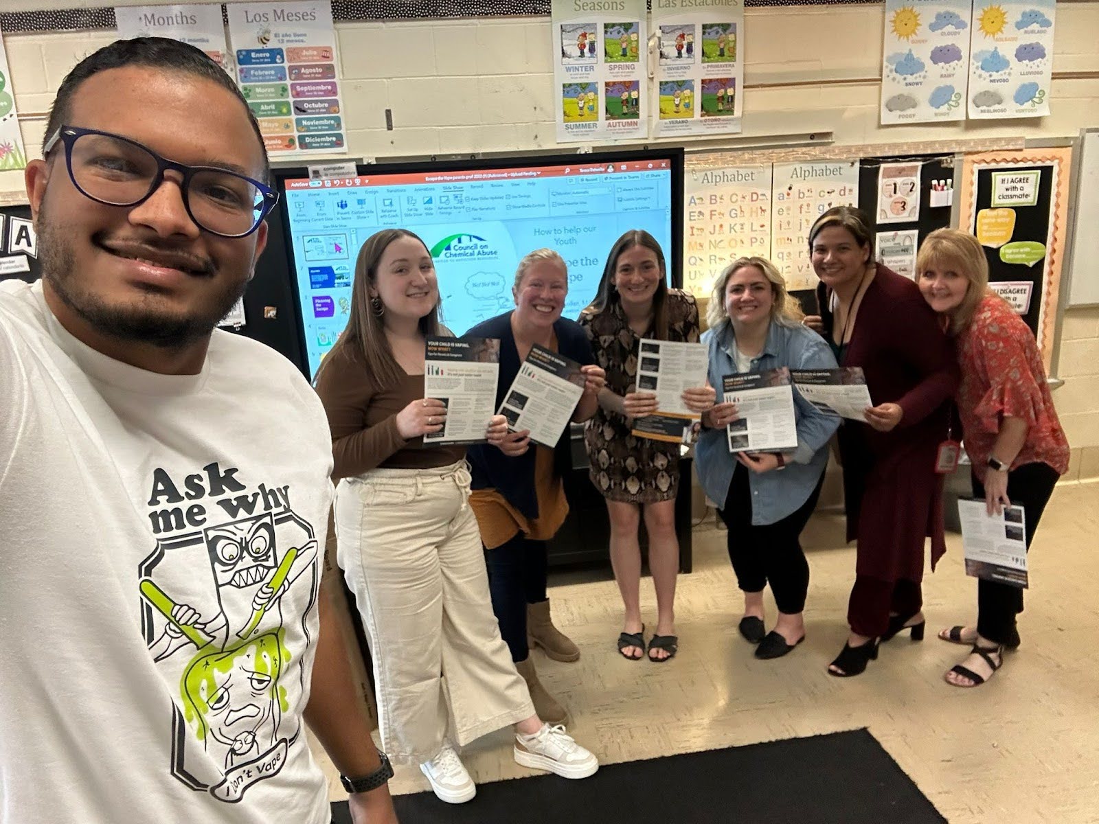 Nico taking a self-fie with a group of students and teachers.
