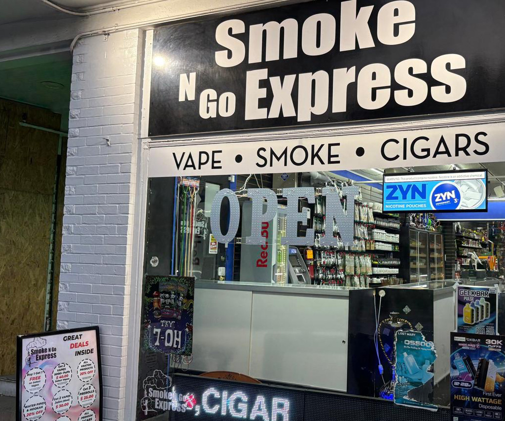 Store front with many tobacco and vape ads and messaging.